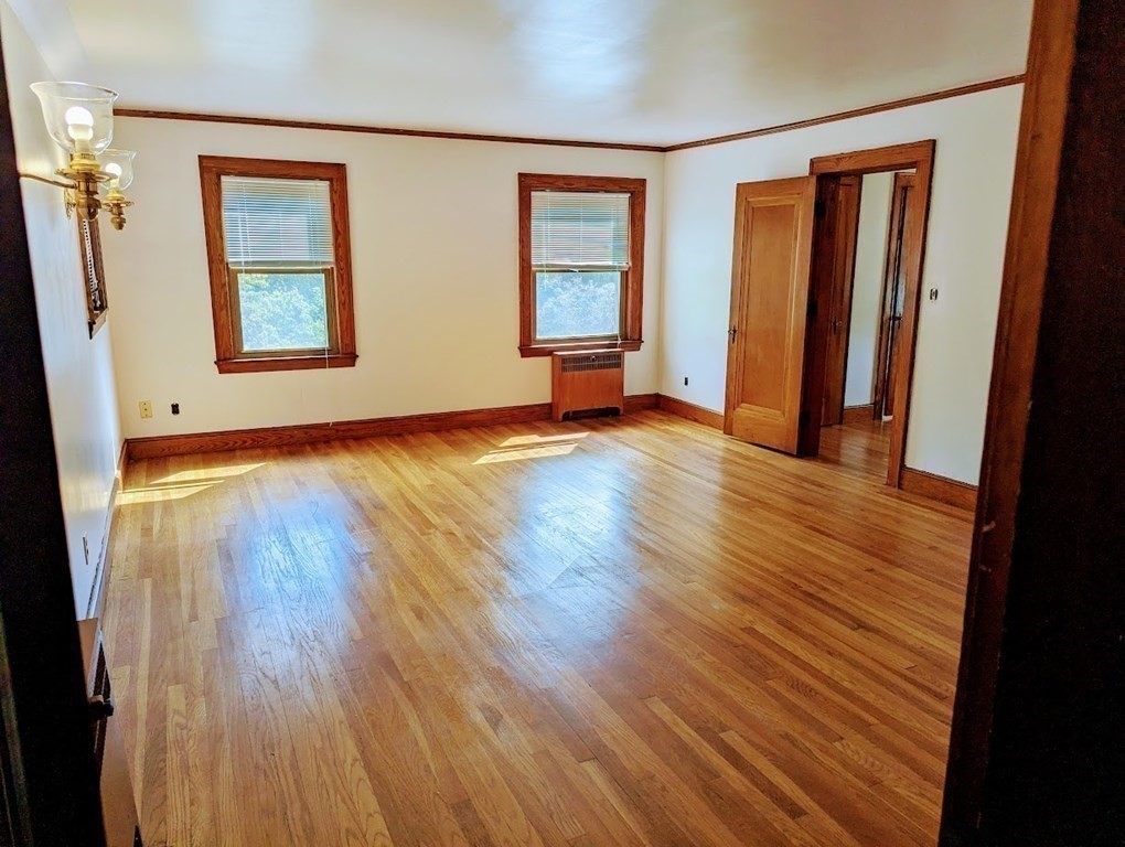 43 Brunswick Road Arlington, MA 02476 - Photo 26 of 42 an empty room with wooden floor and windows