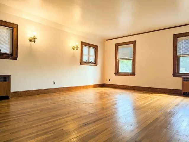 a view of front door with wooden floor and stairs