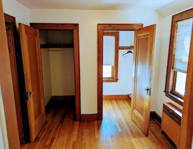a view of room with wooden floor and bathroom