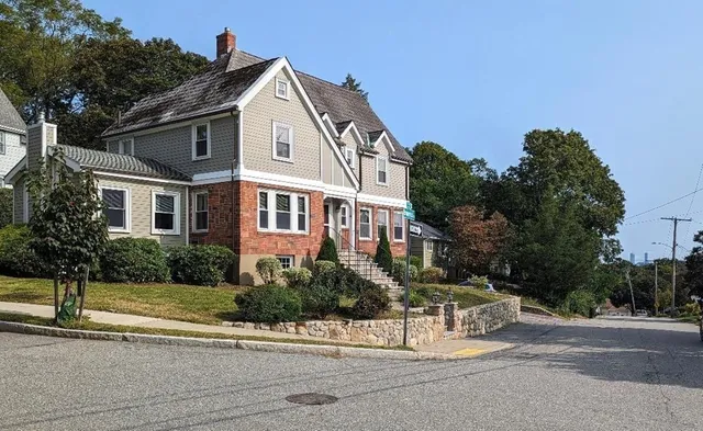 a front view of a house with a garden