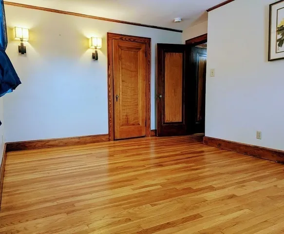 a room with wooden floor and window