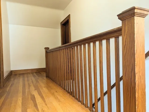 a view of a room with wooden floor and cabinet