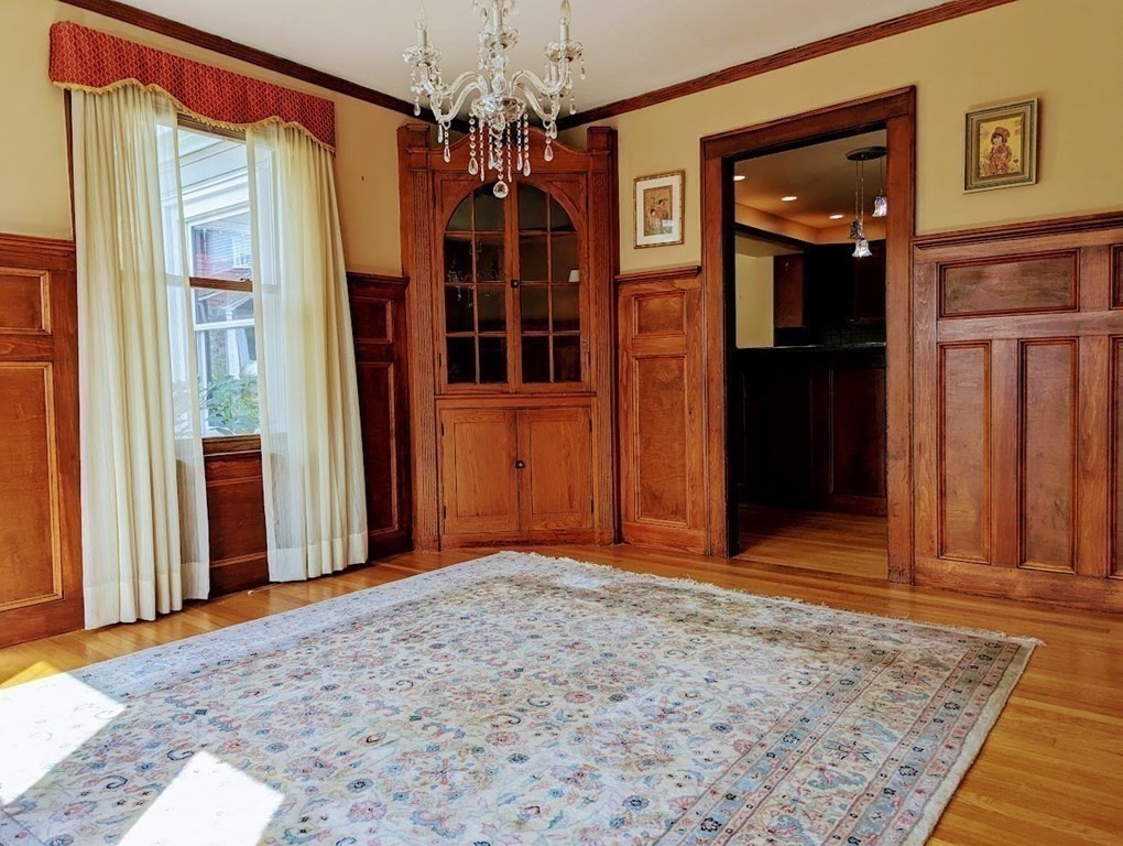 43 Brunswick Road Arlington, MA 02476 - Photo 8 of 42 a view of a hallway with wooden floor and a chandelier