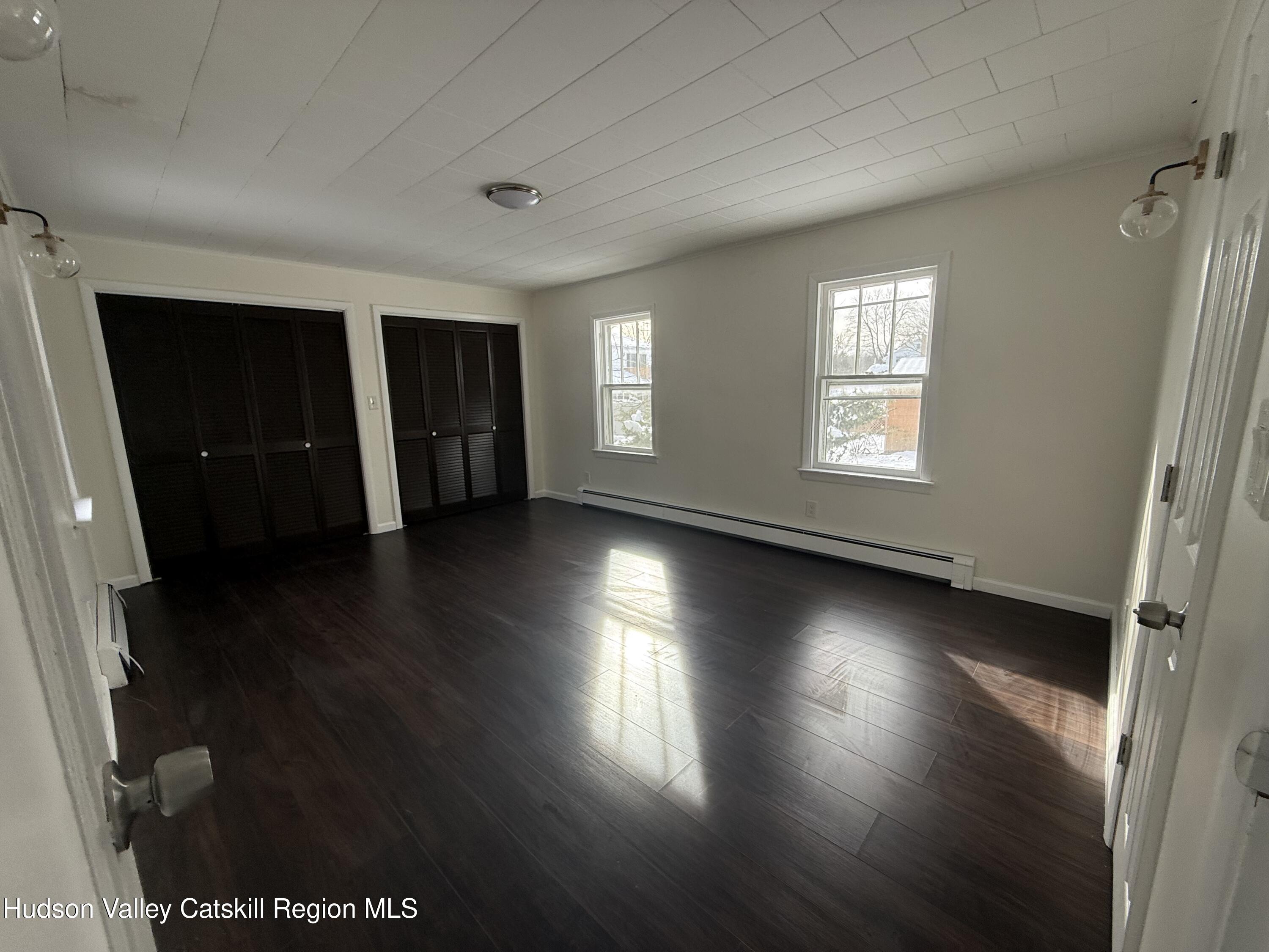 222 Zandhoek Road Hurley, NY 12443 - Photo 10 of 23 an empty room with wooden floor and windows