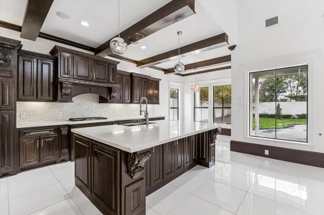 a kitchen with stainless steel appliances granite countertop a sink and a stove