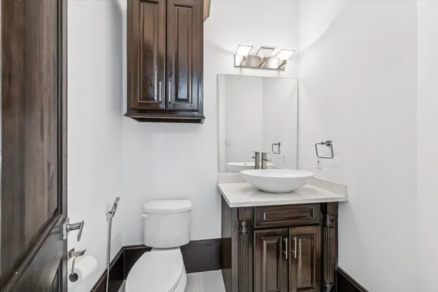a bathroom with a sink a toilet and mirror