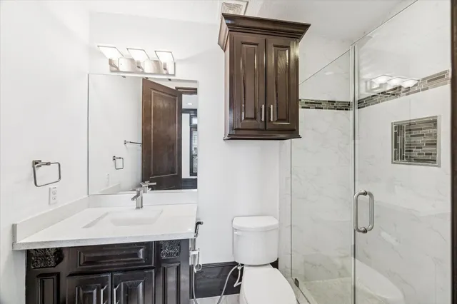 a bathroom with a sink a toilet and mirror