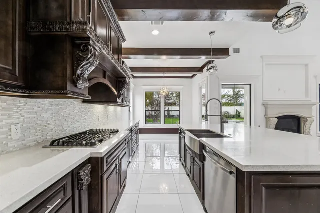 a kitchen with granite countertop a stove and a sink