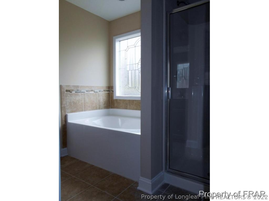 3126 Thrower Road Hope Mills, NC 28348 - Photo 16 of 22 a bathroom with a bathtub and shower
