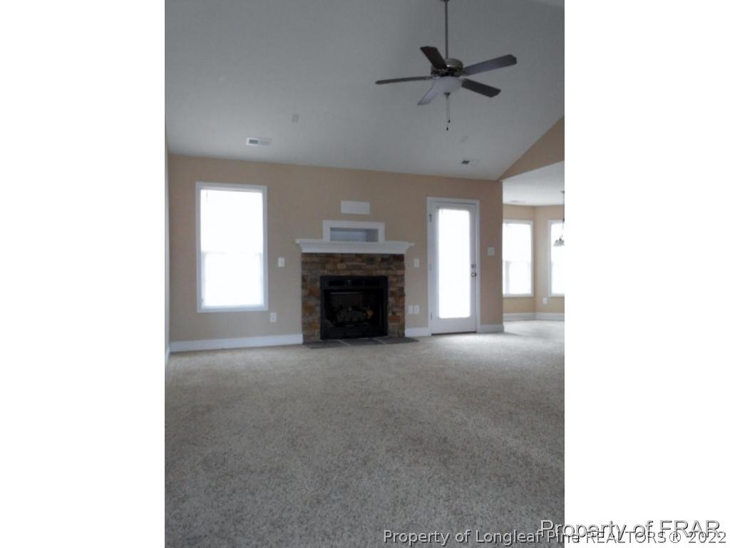 3126 Thrower Road Hope Mills, NC 28348 - Photo 4 of 22 a view of a livingroom with a fireplace and a ceiling fan