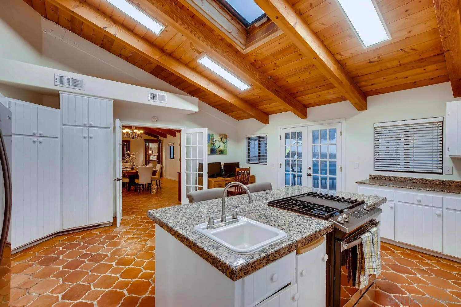 13992 Putney Road Poway, CA 92064 - Photo 13 of 38 a kitchen with stainless steel appliances granite countertop a sink and cabinets