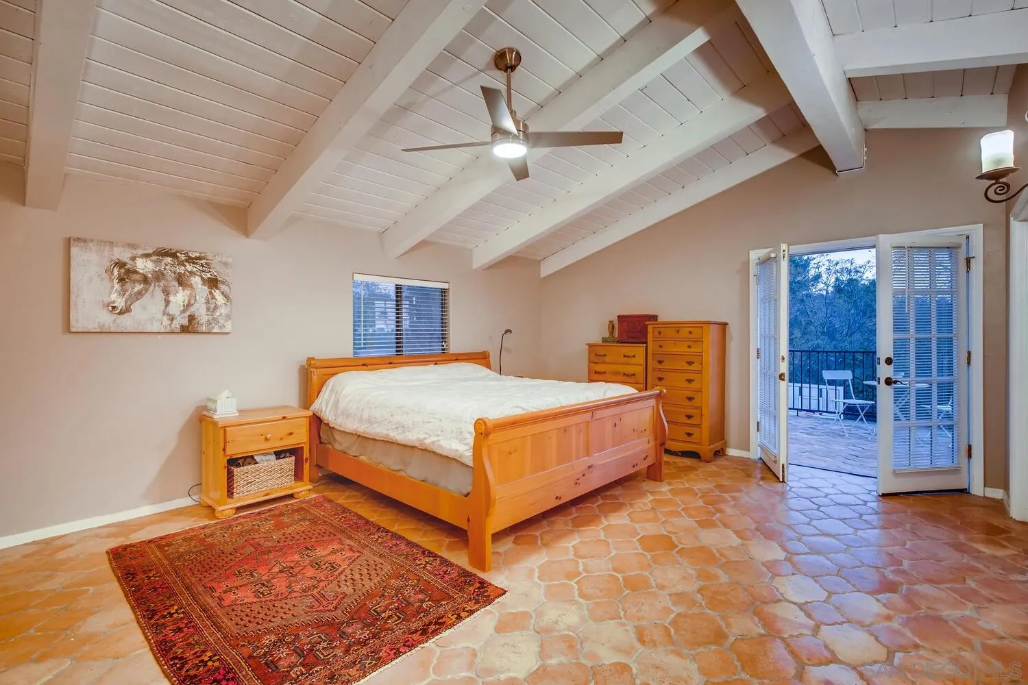 13992 Putney Road Poway, CA 92064 - Photo 23 of 38 a bedroom with a large bed and a chandelier