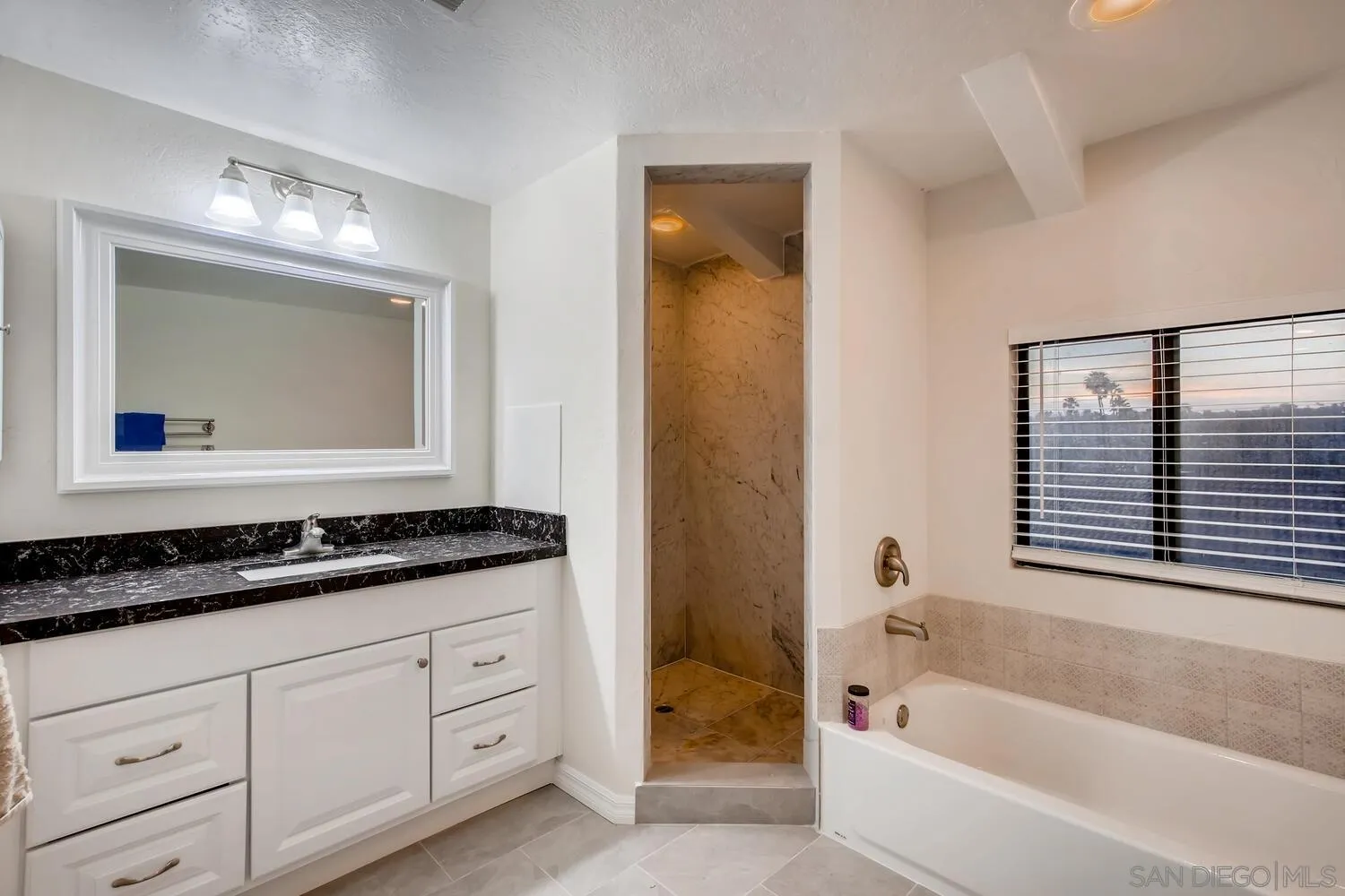 13992 Putney Road Poway, CA 92064 - Photo 30 of 38 a bathroom with a bathtub sink and mirror