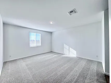 an empty room with a empty space and windows
