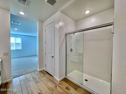 a bathroom with a glass shower door