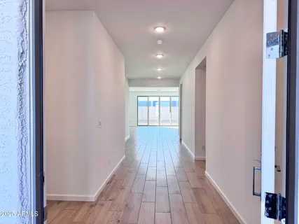 a view of hallway with wooden floor
