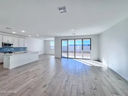 a view of large kitchen with wooden floor and electronic appliances