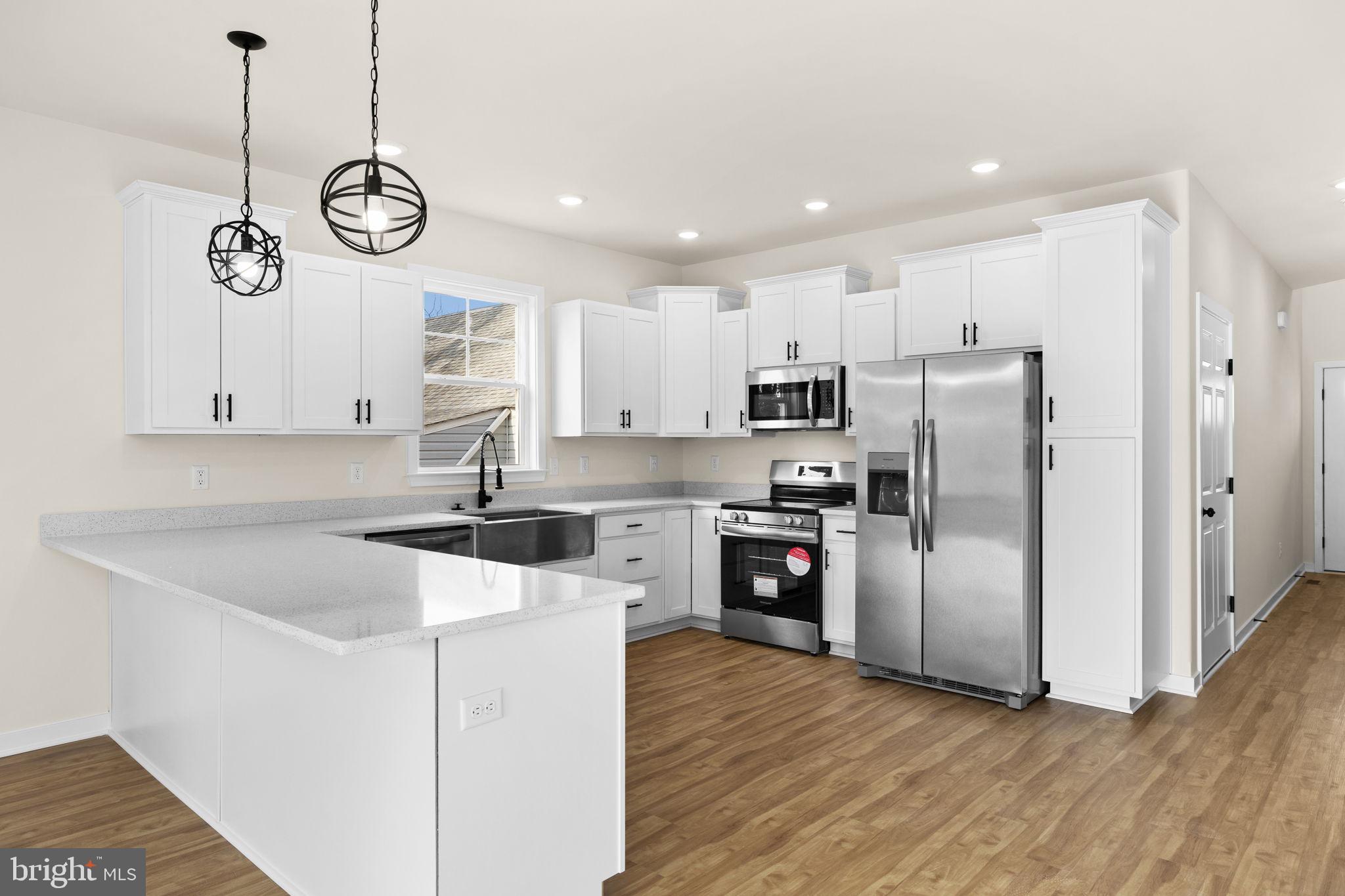 165 Bend Farm Road Fredericksburg, VA 22408 - Photo 18 of 49 a kitchen with stainless steel appliances granite countertop a sink a stove a refrigerator and a refrigerator