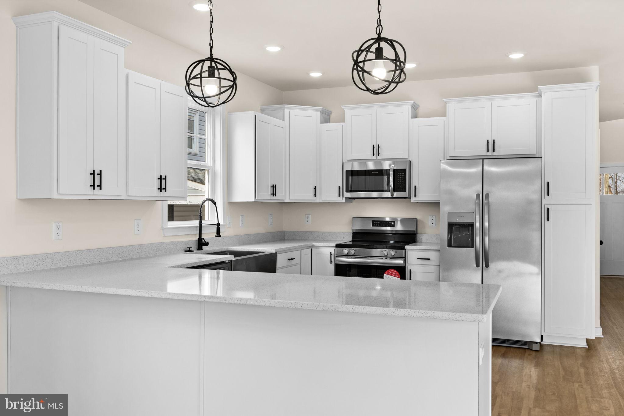 165 Bend Farm Road Fredericksburg, VA 22408 - Photo 21 of 49 a kitchen with stainless steel appliances granite countertop a refrigerator a microwave oven a sink a stove and a refrigerator