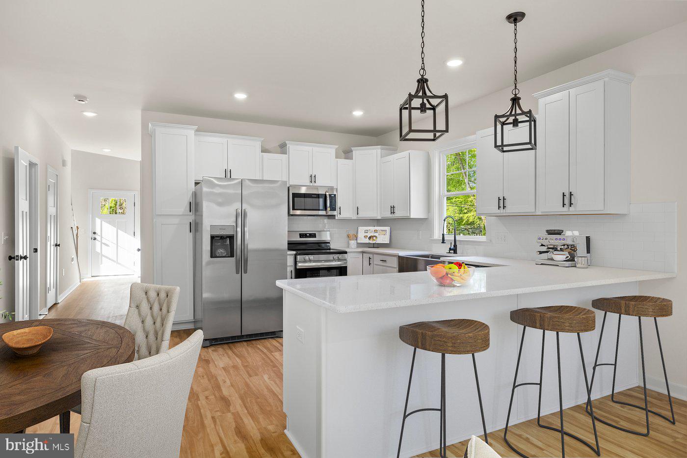 165 Bend Farm Road Fredericksburg, VA 22408 - Photo 3 of 49 a kitchen with stainless steel appliances granite countertop a refrigerator a sink dishwasher a dining table and chairs with wooden floor