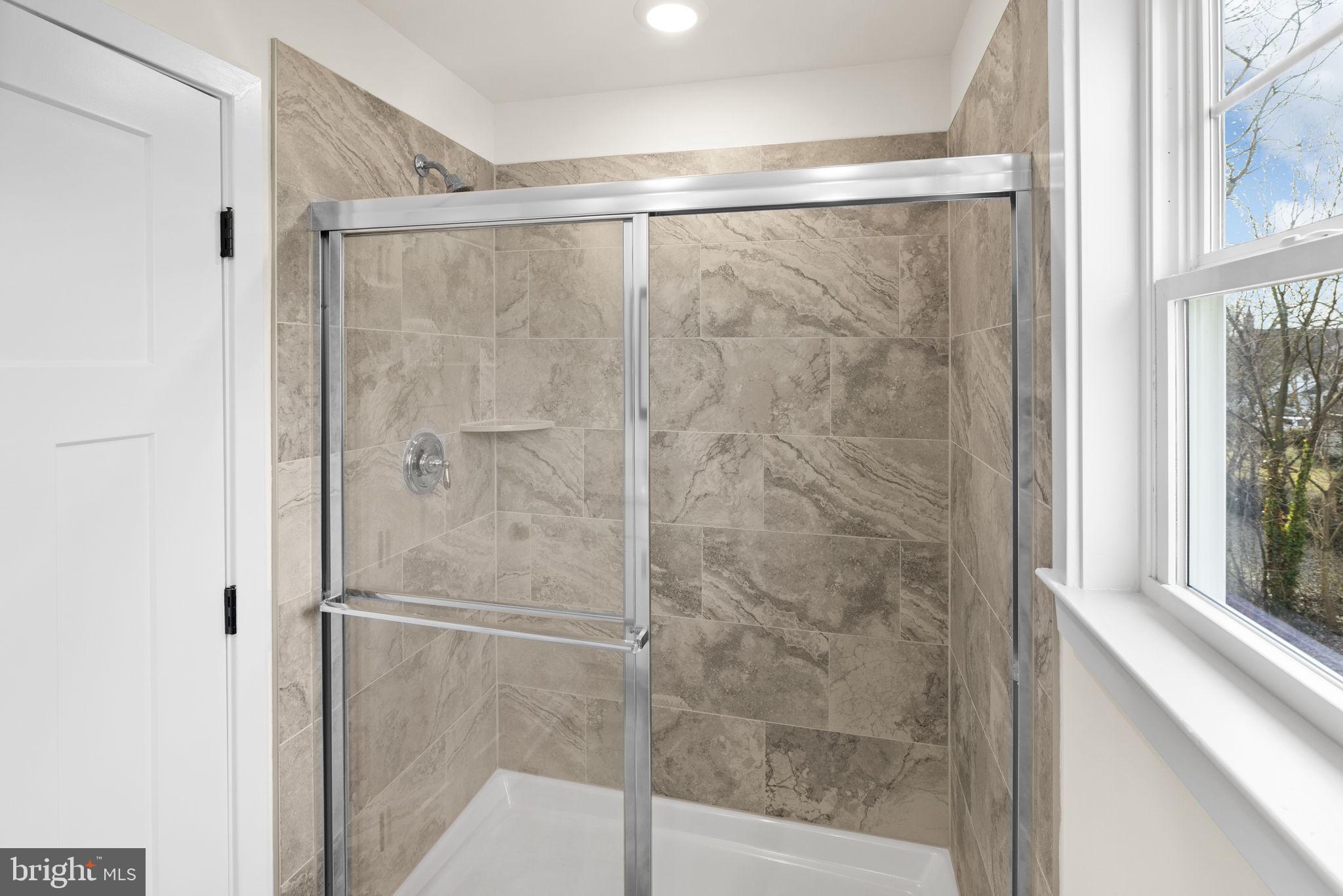 165 Bend Farm Road Fredericksburg, VA 22408 - Photo 34 of 49 a bathroom with a glass shower door