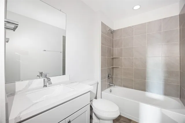 a bathroom with a sink a toilet and bathtub