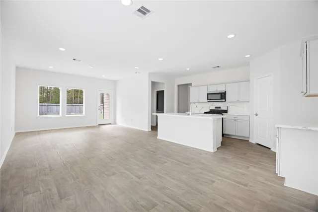 a view of kitchen with cabinets and refrigerator