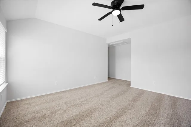 a view of a room with a ceiling fan