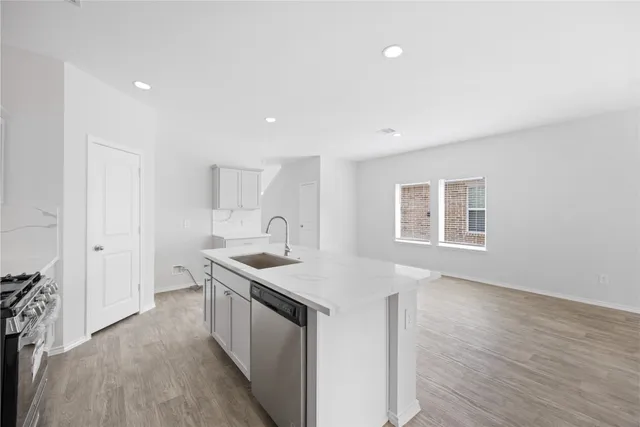 a kitchen with a sink stove and cabinets