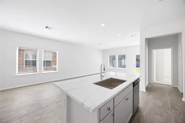 a kitchen that has a sink and a stove in it