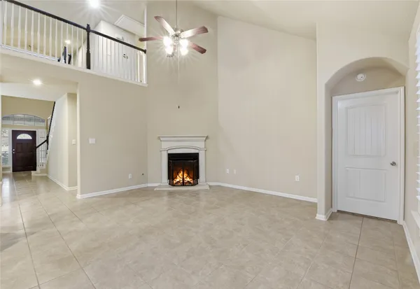 an entryway and a livingroom with a fireplace
