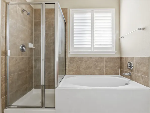 a bathroom with a bathtub and a shower