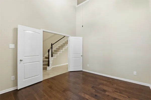 a view of an empty room with wooden floor