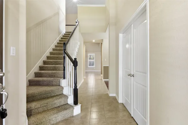 a view of a hallway with wooden floor and entryway