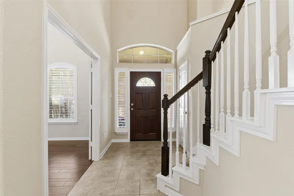 a view of front door with hallway and stairs