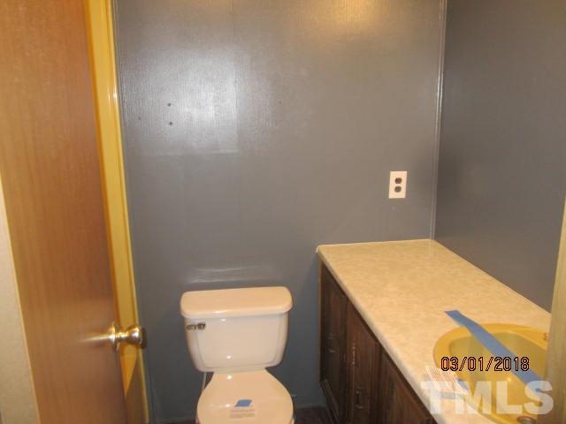 517 James Long Road Roxboro, NC 27574 - Photo 13 of 16 a bathroom with a toilet and a sink