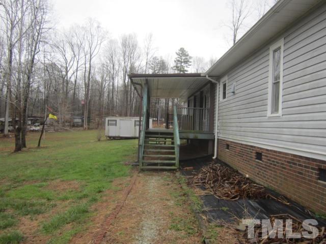 517 James Long Road Roxboro, NC 27574 - Photo 5 of 16 a front view of a house with garden