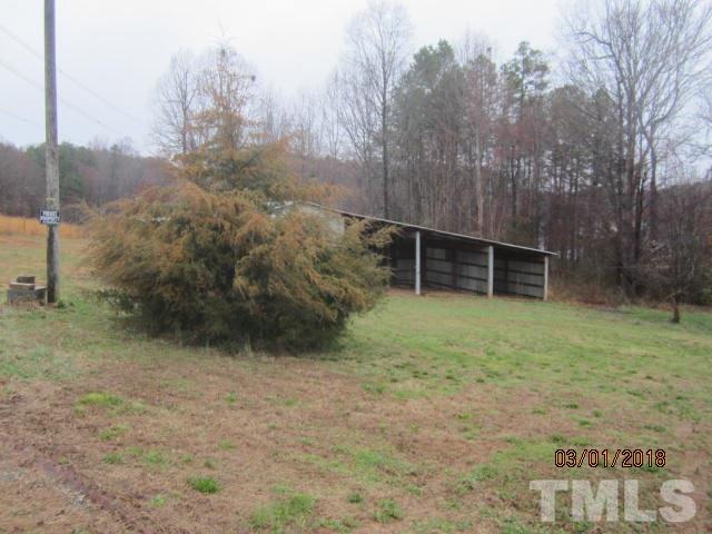 517 James Long Road Roxboro, NC 27574 - Photo 7 of 16 a backyard of a house with lots of green space