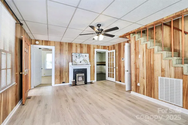 a view of an empty room with a fireplace and a window
