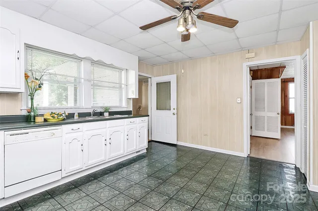 a large kitchen with cabinets and a window