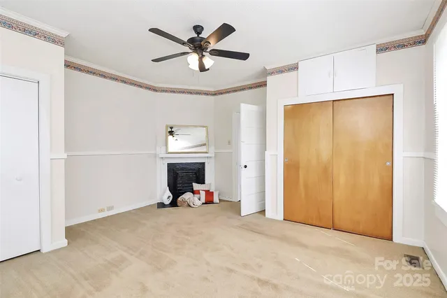 a view of a livingroom with a fireplace and a ceiling fan