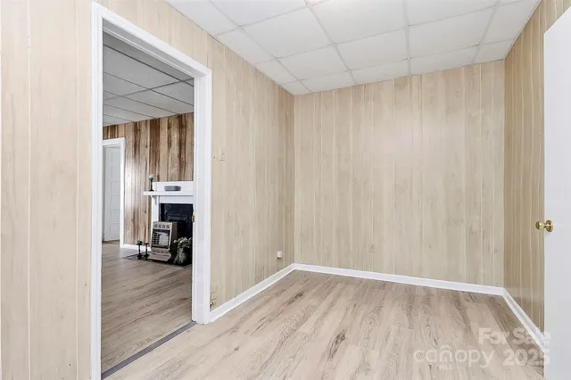 a view of empty room with wooden floor and cabinet