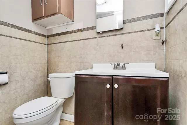a bathroom with a sink toilet and vanity