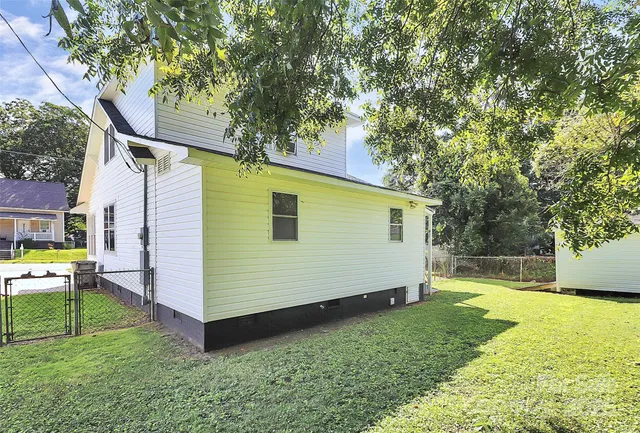 a view of a backyard with a large tree