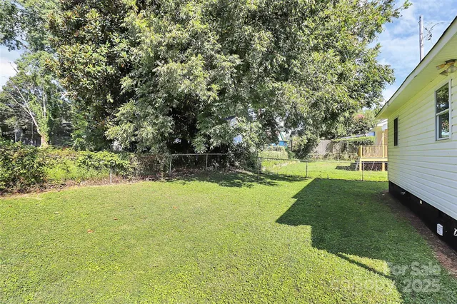 a view of a backyard with large trees
