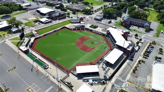 an aerial view of a tennis ground and a lots of buildings