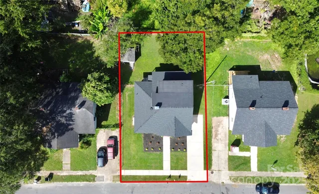 an aerial view of multiple houses with yard