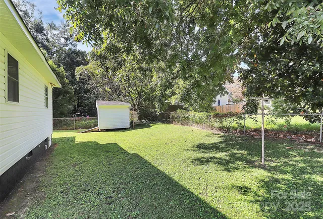 a backyard of a house with a garden and plants