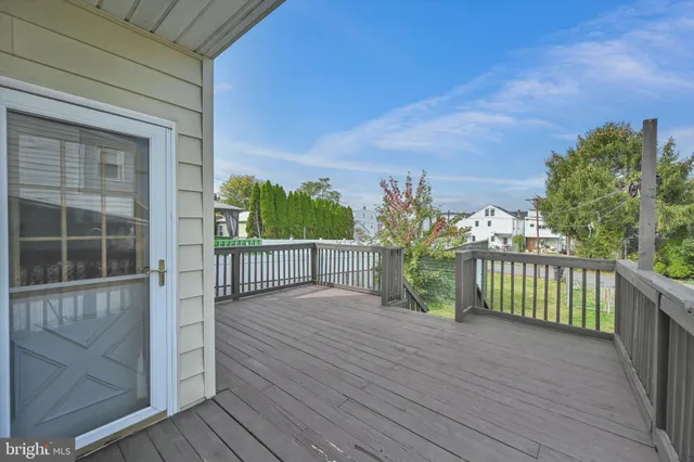 a view of a balcony with wooden floor