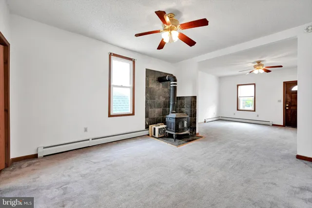 a view of room with workspace and windows